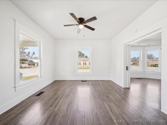 402 E Patti Page Blvd, Claremore, OK 74017 - unfurnished room featuring dark wood-type flooring and a ceiling fan