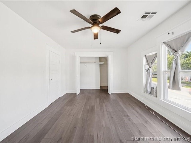 402 E Patti Page Blvd, Claremore, OK 74017 - unfurnished bedroom with a closet, wood finished floors, and a ceiling fan