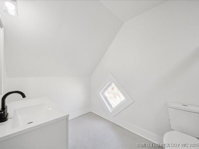 402 E Patti Page Blvd, Claremore, OK 74017 - bathroom with vaulted ceiling and vanity