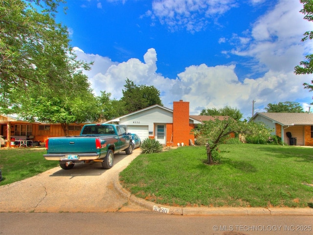 6330 Norman Ave, Oklahoma City, OK 73122 - ranch-style house featuring driveway, an attached garage, and a front yard