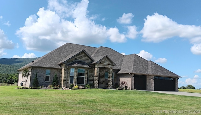 23708 Wolf Crest Way, Wister, OK 74966 - french country inspired facade featuring brick siding, a garage, driveway, and a front lawn