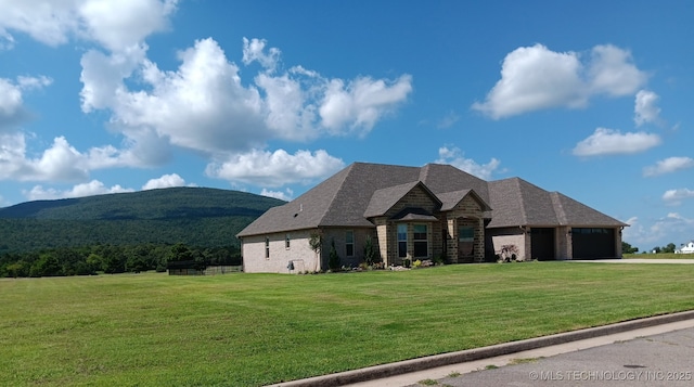 23708 Wolf Crest Way, Wister, OK 74966 - french country home featuring a garage, a mountain view, a front lawn, and driveway