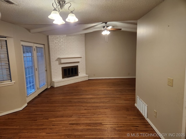 1669 S Pine Ave W, Broken Arrow, OK 74012 - unfurnished living room featuring a textured ceiling, wood finished floors, a chandelier, a fireplace, and ceiling fan
