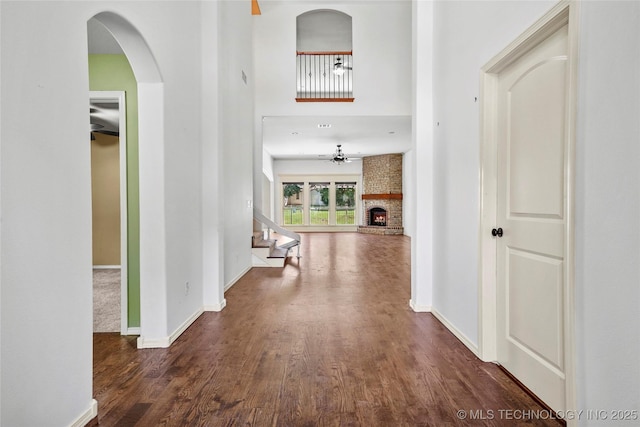 7816 E Galveston St, Broken Arrow, OK 74014 - hallway with wood finished floors, stairway, and arched walkways