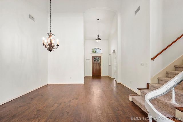 7816 E Galveston St, Broken Arrow, OK 74014 - foyer entrance with a towering ceiling, arched walkways, dark wood-type flooring, stairs, and a chandelier