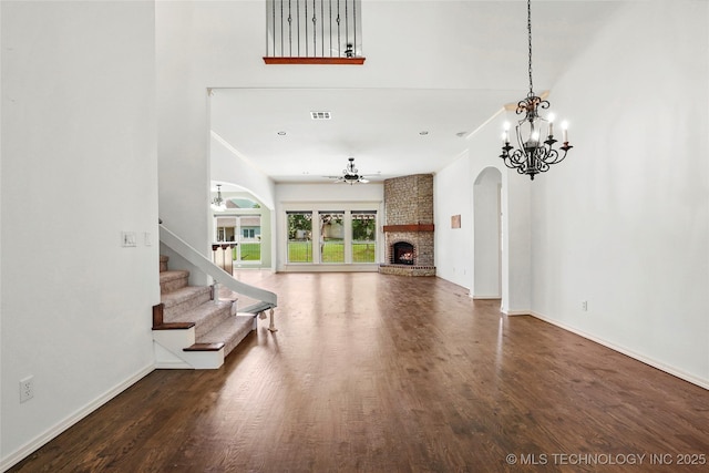 7816 E Galveston St, Broken Arrow, OK 74014 - unfurnished living room with a chandelier, arched walkways, and wood finished floors