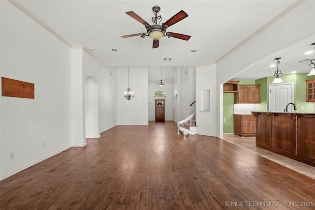 7816 E Galveston St, Broken Arrow, OK 74014 - unfurnished living room with ceiling fan, wood finished floors, stairway, recessed lighting, and crown molding