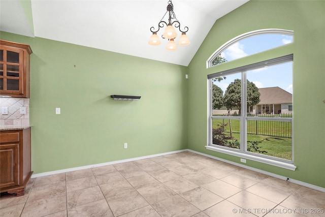7816 E Galveston St, Broken Arrow, OK 74014 - unfurnished dining area featuring vaulted ceiling and a chandelier