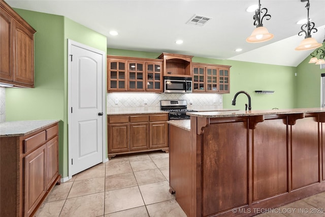 7816 E Galveston St, Broken Arrow, OK 74014 - kitchen featuring stainless steel appliances, tasteful backsplash, a breakfast bar area, light stone countertops, and hanging light fixtures