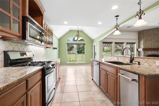 7816 E Galveston St, Broken Arrow, OK 74014 - kitchen featuring appliances with stainless steel finishes, tasteful backsplash, light stone countertops, pendant lighting, and lofted ceiling