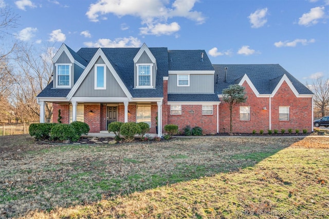 4704 W 88th St, Tulsa, OK 74132 - traditional-style home with brick siding, a front lawn, a porch, and roof with shingles
