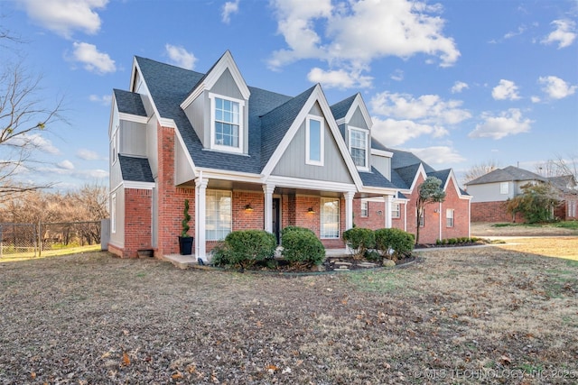 4704 W 88th St, Tulsa, OK 74132 - view of front of house with brick siding, a porch, and a shingled roof