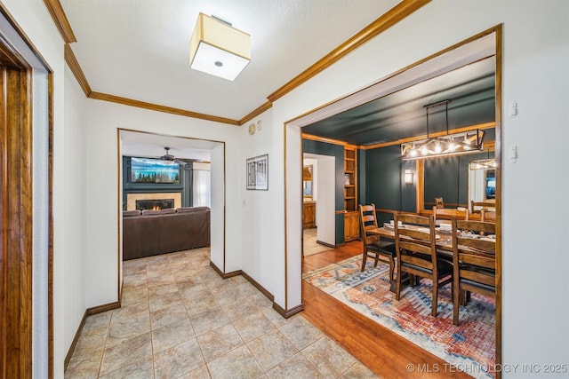 4704 W 88th St, Tulsa, OK 74132 - dining space with ornamental molding, a warm lit fireplace, and a ceiling fan