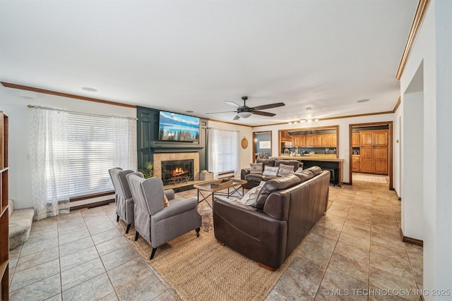 4704 W 88th St, Tulsa, OK 74132 - living room with a lit fireplace, a ceiling fan, plenty of natural light, and crown molding