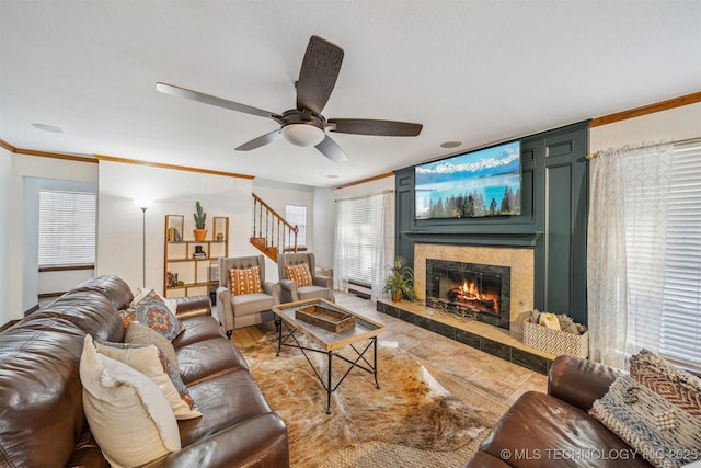 4704 W 88th St, Tulsa, OK 74132 - living room with a tile fireplace, ornamental molding, stairs, and a ceiling fan