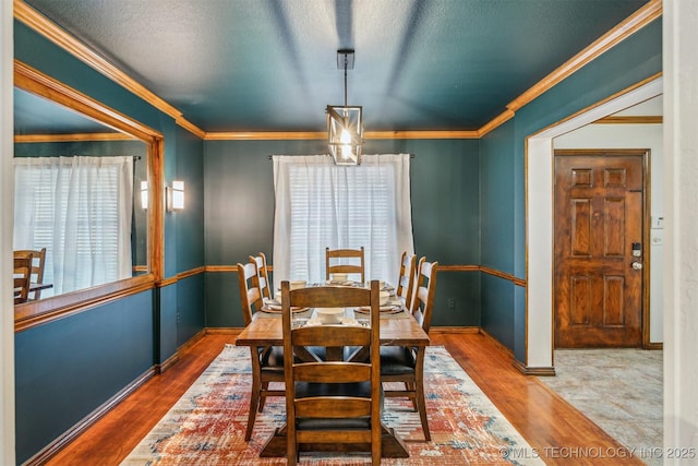 4704 W 88th St, Tulsa, OK 74132 - dining area with wood finished floors, crown molding, and a textured ceiling