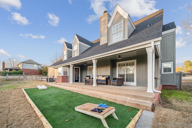 4704 W 88th St, Tulsa, OK 74132 - back of house featuring an outdoor hangout area, a patio, a chimney, roof with shingles, and board and batten siding