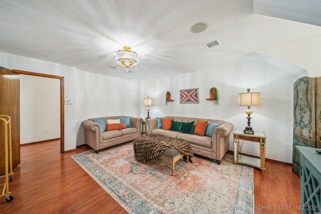 4704 W 88th St, Tulsa, OK 74132 - living area featuring wood finished floors and a chandelier