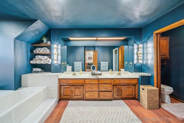 4704 W 88th St, Tulsa, OK 74132 - full bath featuring double vanity, a bath, wood finished floors, and a textured ceiling