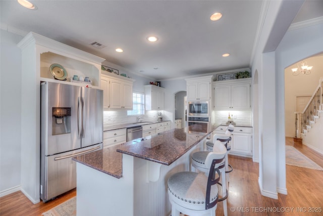 8414 E 99th Pl, Tulsa, OK 74133 - kitchen with stainless steel appliances, white cabinetry, ornamental molding, open shelves, and recessed lighting