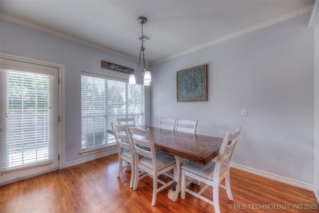 8414 E 99th Pl, Tulsa, OK 74133 - dining room featuring crown molding and light wood-style flooring