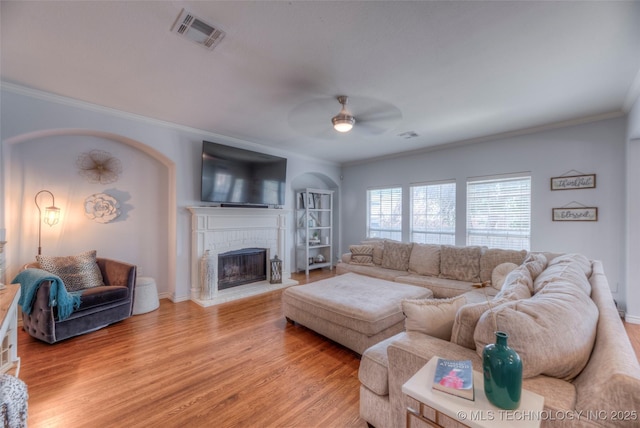 8414 E 99th Pl, Tulsa, OK 74133 - living area featuring ornamental molding, a ceiling fan, a fireplace, and light wood finished floors
