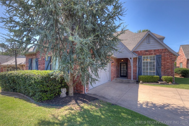 8414 E 99th Pl, Tulsa, OK 74133 - view of front of home with brick siding, driveway, an attached garage, a shingled roof, and a front yard