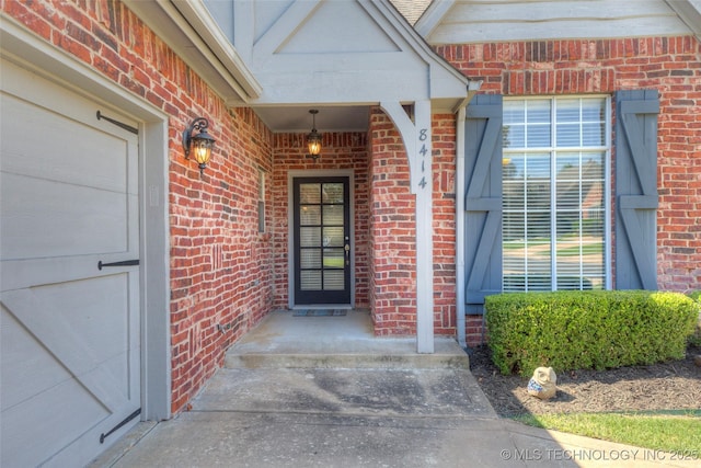 8414 E 99th Pl, Tulsa, OK 74133 - doorway to property featuring brick siding
