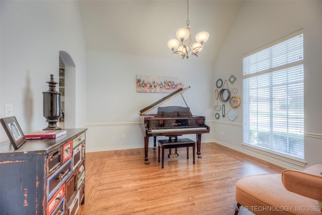8414 E 99th Pl, Tulsa, OK 74133 - sitting room featuring plenty of natural light, a chandelier, light wood-style flooring, high vaulted ceiling, and arched walkways