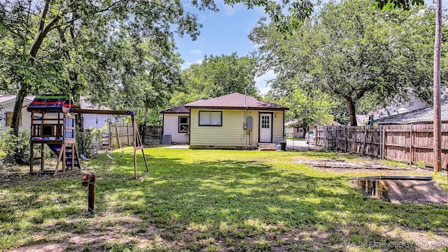1412 Healdton Blvd, Ardmore, OK 73401 - rear view of property featuring a playground, entry steps, a fenced backyard, and crawl space