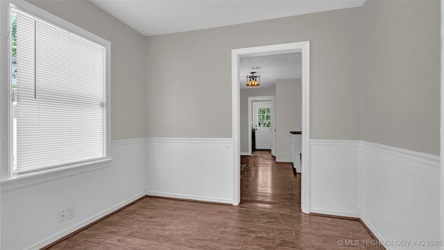 1412 Healdton Blvd, Ardmore, OK 73401 - unfurnished room with wood finished floors and a wainscoted wall