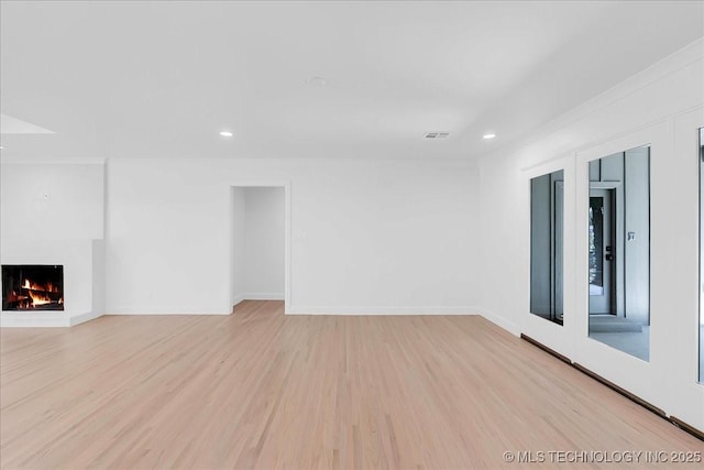 4155 S Birmingham Pl, Tulsa, OK 74105 - unfurnished living room featuring light wood-style floors, a lit fireplace, and recessed lighting