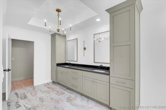4155 S Birmingham Pl, Tulsa, OK 74105 - bathroom featuring a chandelier, a raised ceiling, double vanity, recessed lighting, and marble look tiles