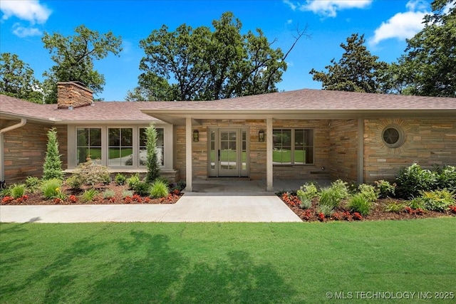 4155 S Birmingham Pl, Tulsa, OK 74105 - doorway to property featuring a yard, stone siding, a chimney, and roof with shingles