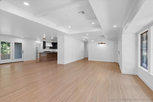 4155 S Birmingham Pl, Tulsa, OK 74105 - unfurnished living room with plenty of natural light, light wood-type flooring, and recessed lighting