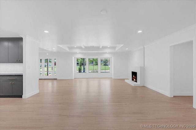4155 S Birmingham Pl, Tulsa, OK 74105 - unfurnished living room with recessed lighting, light wood-style flooring, and a lit fireplace
