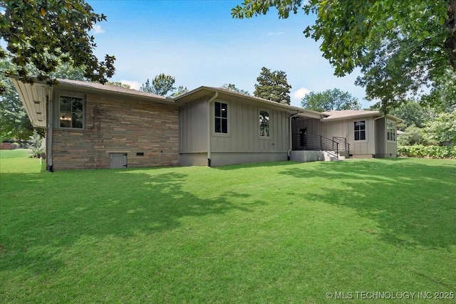 4155 S Birmingham Pl, Tulsa, OK 74105 - back of property with board and batten siding and a yard