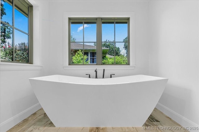 4155 S Birmingham Pl, Tulsa, OK 74105 - bathroom featuring a soaking tub and healthy amount of natural light