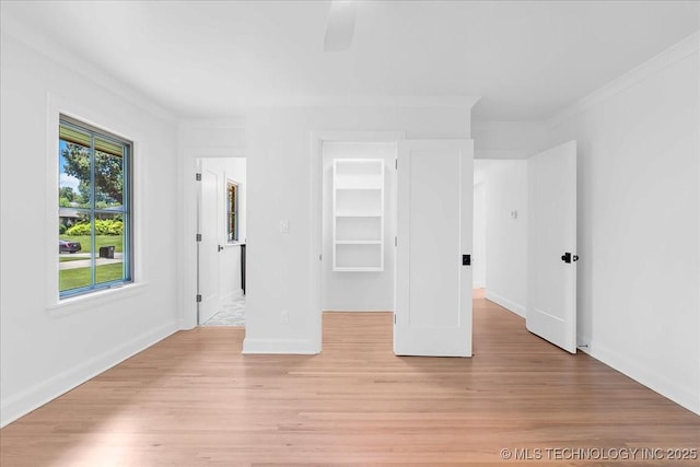4155 S Birmingham Pl, Tulsa, OK 74105 - unfurnished bedroom featuring ornamental molding, a spacious closet, light wood-type flooring, and ceiling fan