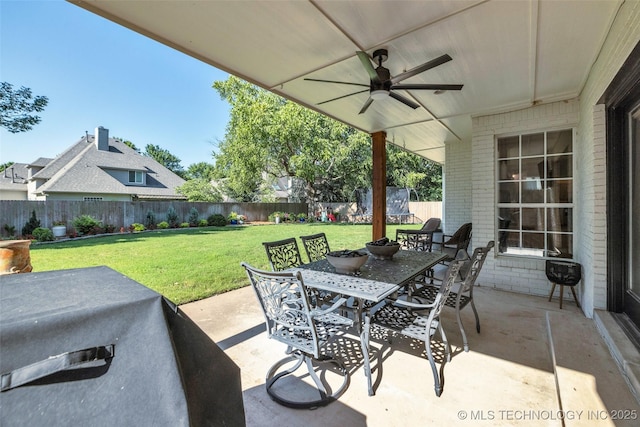 5414 E 109th Pl, Tulsa, OK 74137 - fenced backyard featuring outdoor dining area, ceiling fan, a patio area, and area for grilling