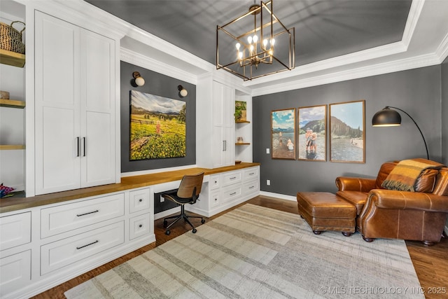 5414 E 109th Pl, Tulsa, OK 74137 - office featuring built in desk, dark wood-type flooring, a tray ceiling, a chandelier, and crown molding