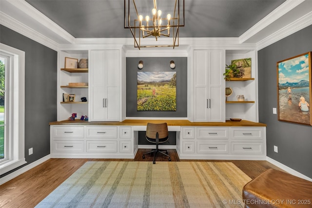 5414 E 109th Pl, Tulsa, OK 74137 - home office featuring built in desk, wood finished floors, a chandelier, and ornamental molding