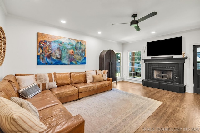 5414 E 109th Pl, Tulsa, OK 74137 - living area with wood finished floors, a ceiling fan, a tile fireplace, recessed lighting, and ornamental molding