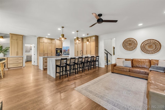 5414 E 109th Pl, Tulsa, OK 74137 - living room featuring a ceiling fan, recessed lighting, light wood-style flooring, and stairs