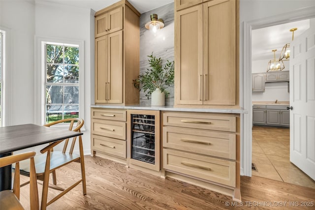 5414 E 109th Pl, Tulsa, OK 74137 - indoor dry bar featuring wine cooler, light tile patterned floors, and a chandelier
