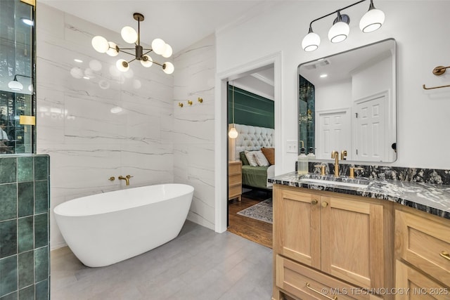 5414 E 109th Pl, Tulsa, OK 74137 - ensuite bathroom featuring tile walls, a freestanding bath, vanity, a chandelier, and crown molding
