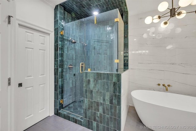 5414 E 109th Pl, Tulsa, OK 74137 - full bath with a shower stall, a freestanding tub, a chandelier, and tile patterned floors