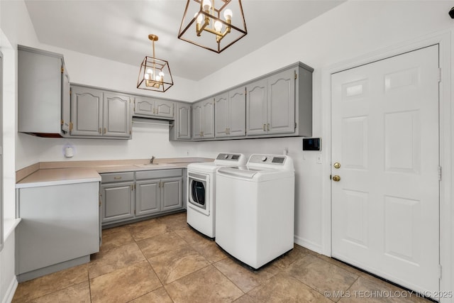 5414 E 109th Pl, Tulsa, OK 74137 - laundry room with washer and clothes dryer, cabinet space, and a chandelier