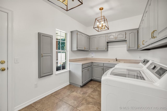 5414 E 109th Pl, Tulsa, OK 74137 - washroom with a chandelier, independent washer and dryer, cabinet space, and light tile patterned flooring