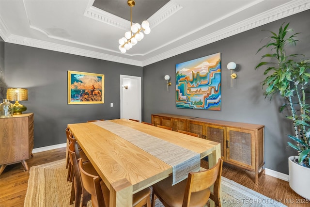 5414 E 109th Pl, Tulsa, OK 74137 - dining room with a raised ceiling, wood finished floors, crown molding, and a chandelier